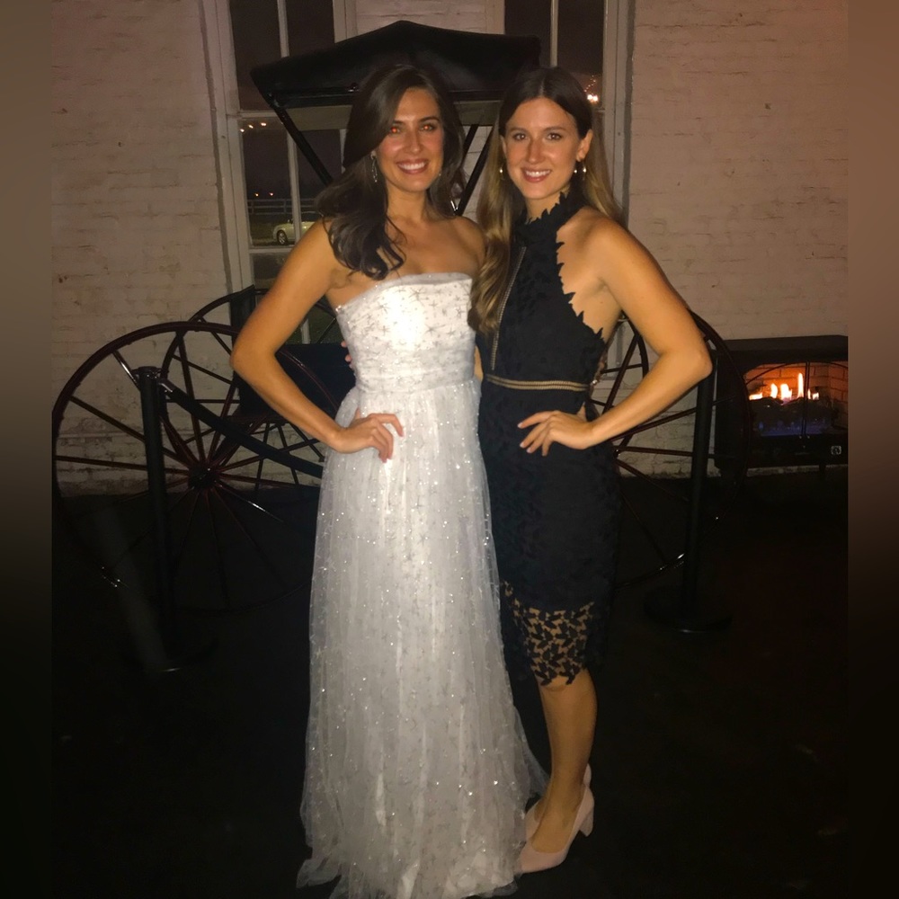 High neck, knee length, black cocktail dress. Floral lace overlay. Open back.
